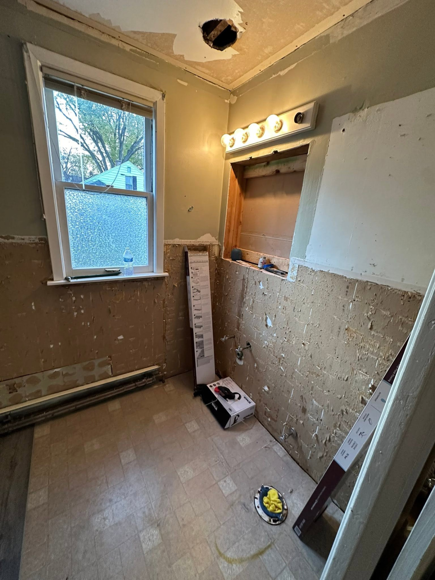 Bathroom stripped for a full remodel with fixtures and wall finishes removed