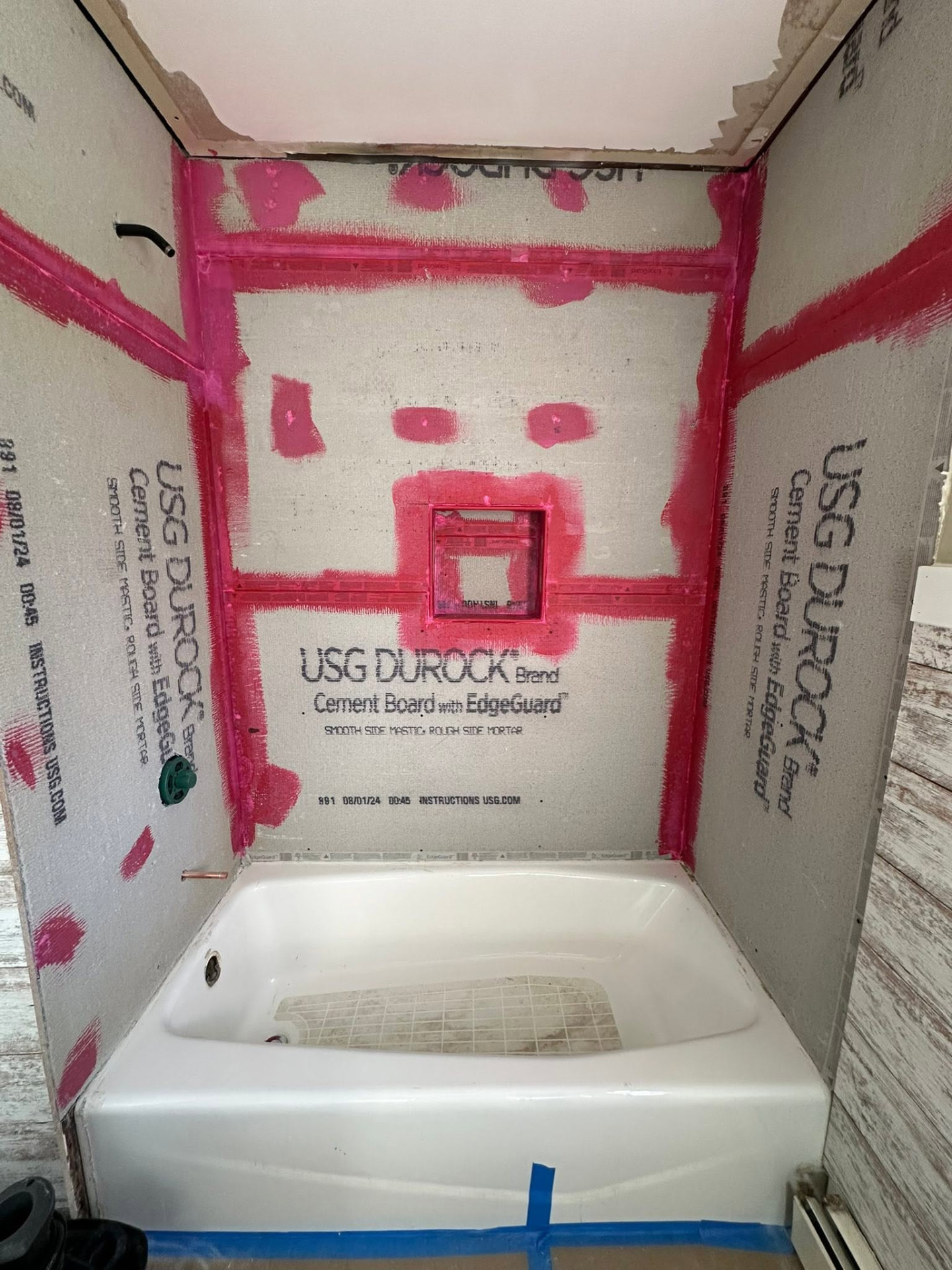 Tub surround prepped with cement board and waterproofing before tile
