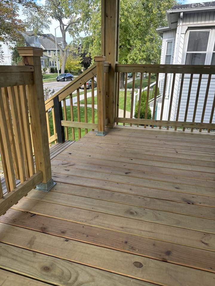 Finished covered porch deck with new pressure-treated railing and decking
