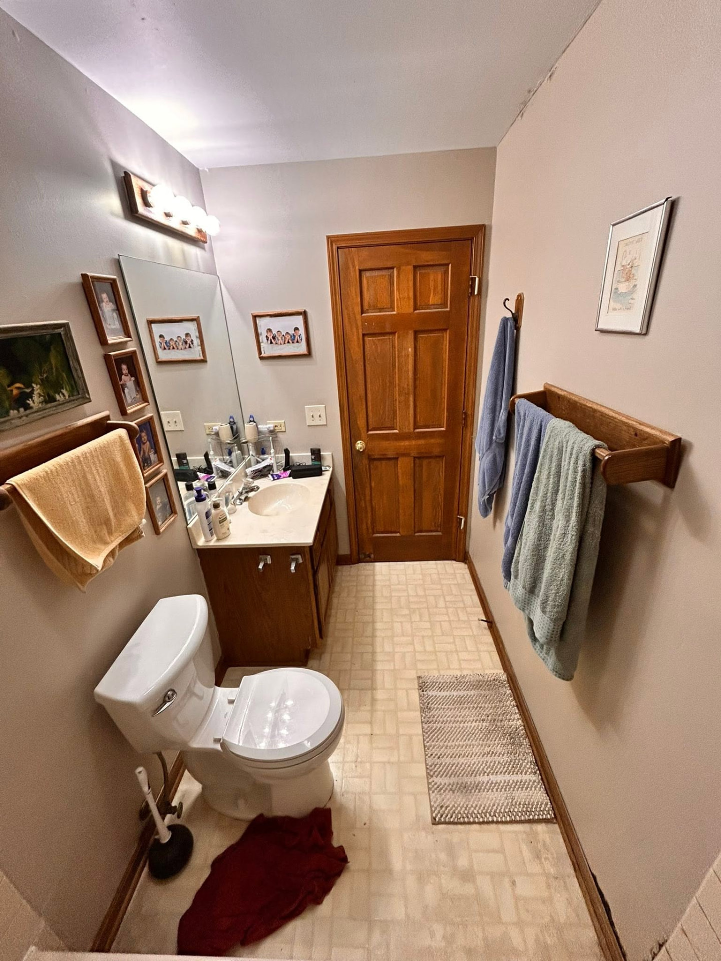 Bathroom before renovation with dated vanity and flooring