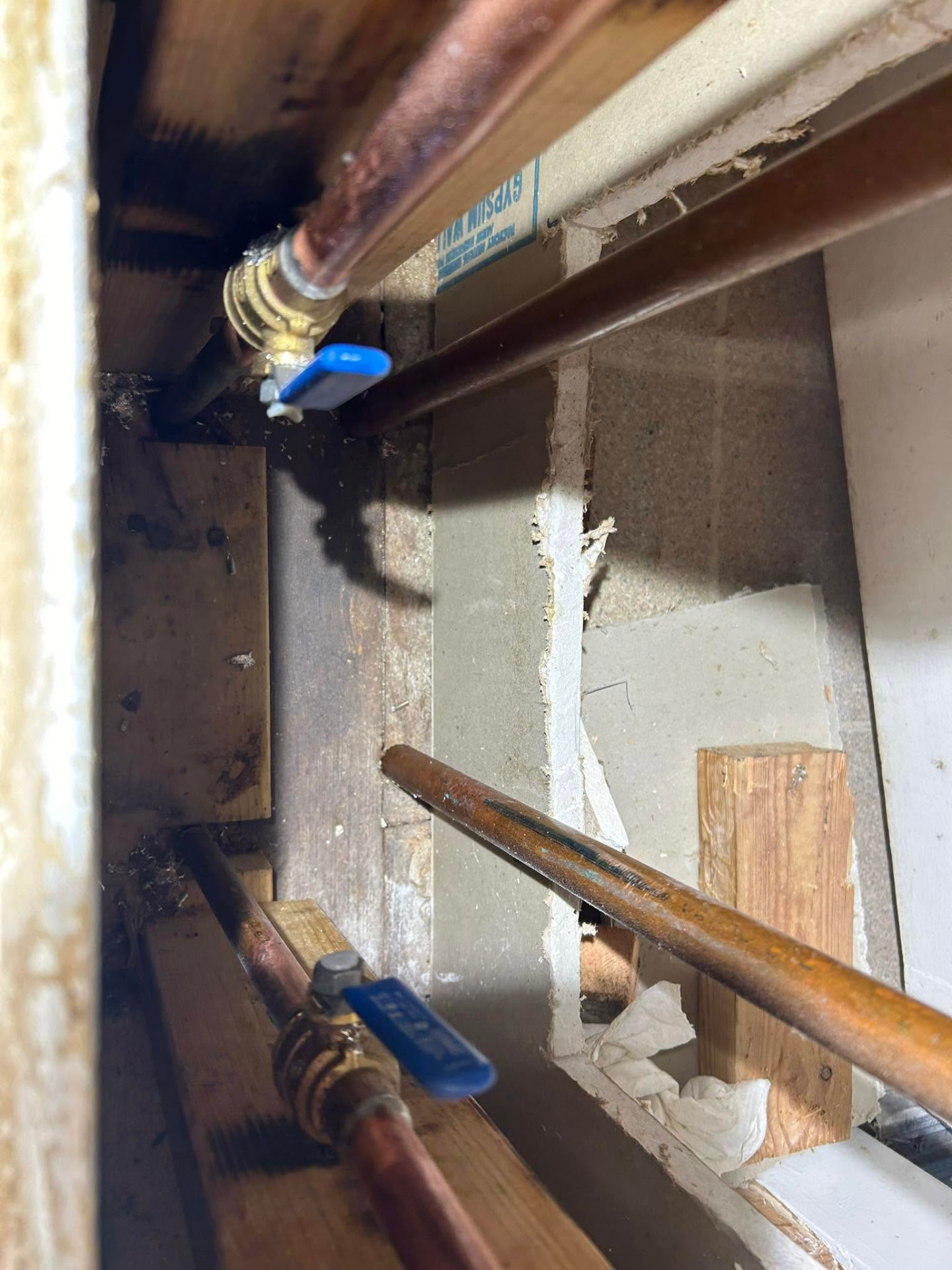 Copper water lines and shutoff valves inside an open wall