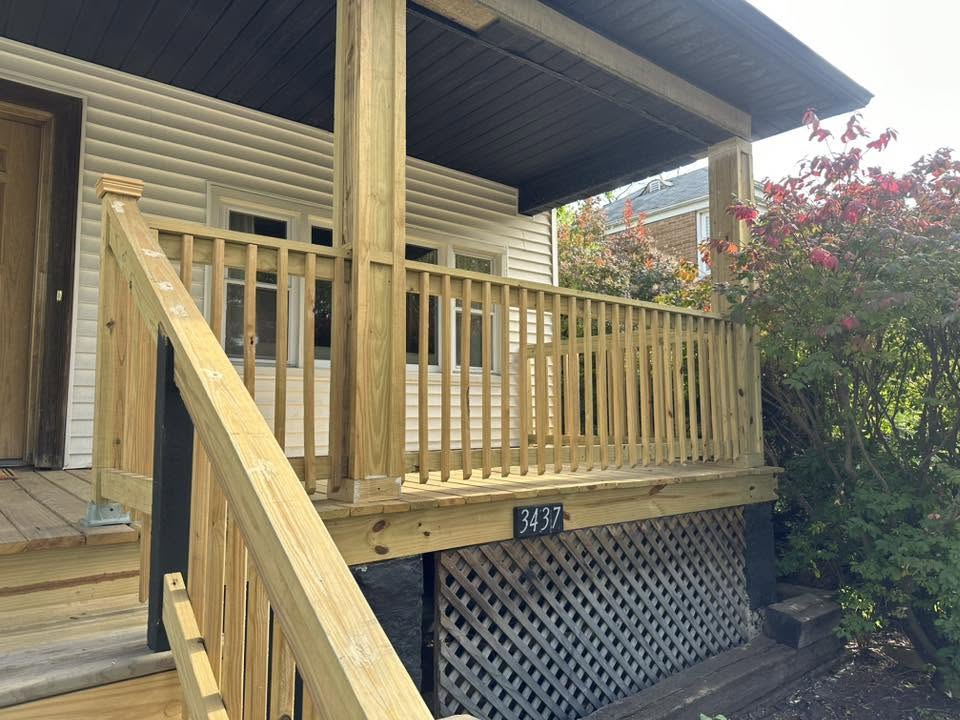 Rebuilt covered front porch with pressure-treated railing and lattice skirting