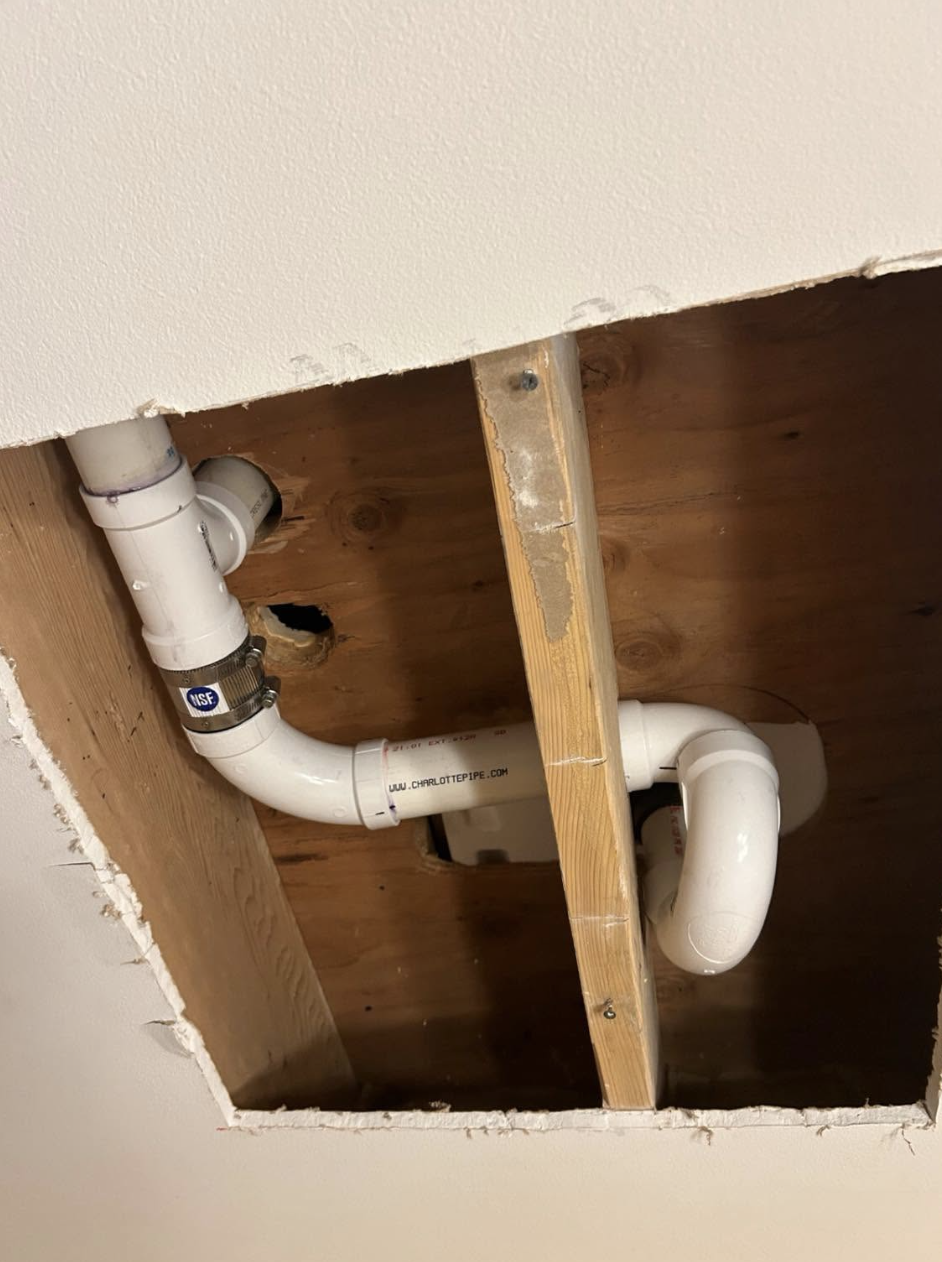 New PVC drain and trap installed inside an open ceiling