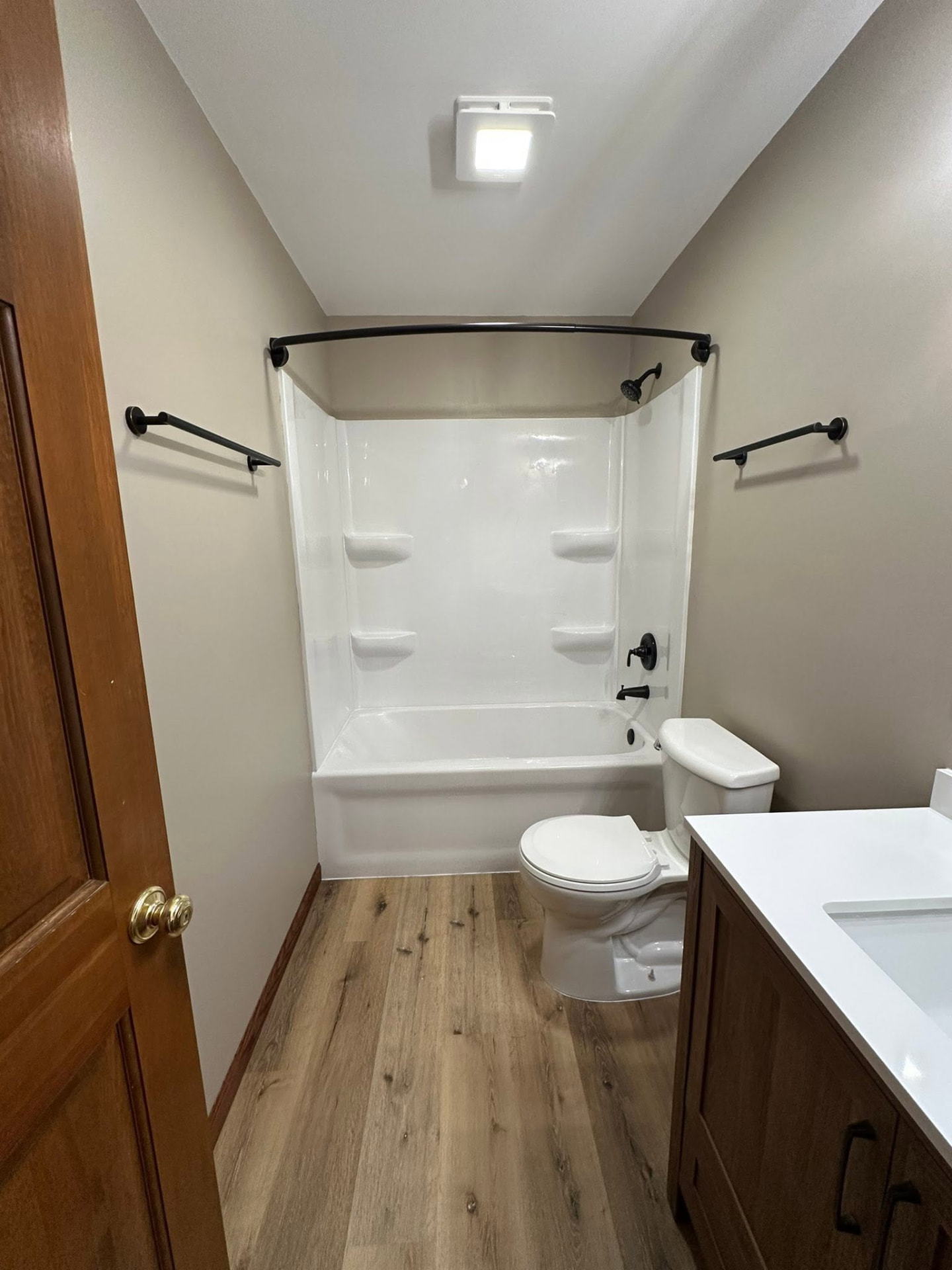 Completed bathroom with new tub surround, flooring and fixtures