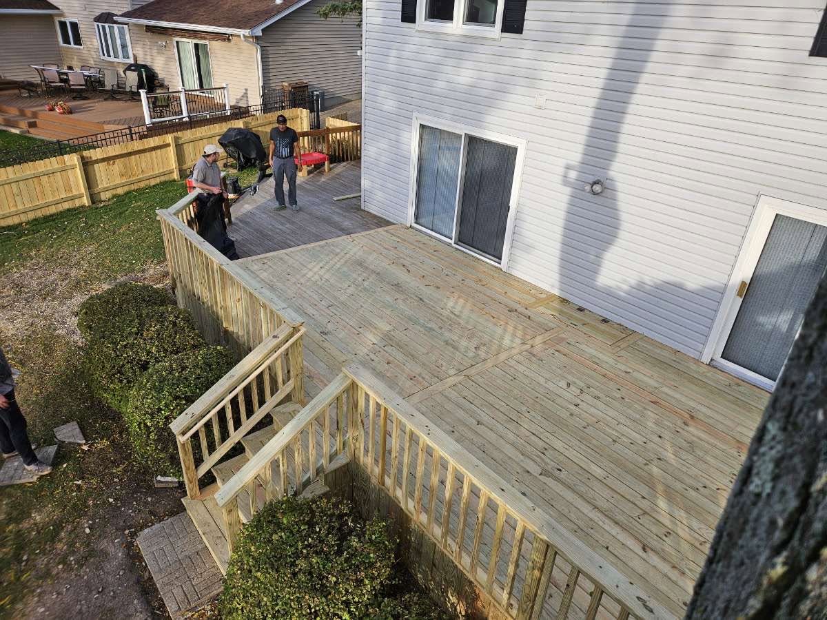 Large multi-level pressure-treated deck built off a sliding patio door