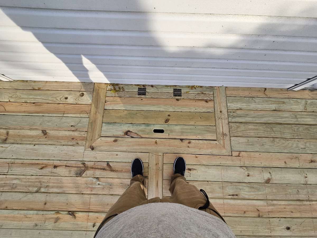 Custom framed access hatch built into a new pressure-treated deck