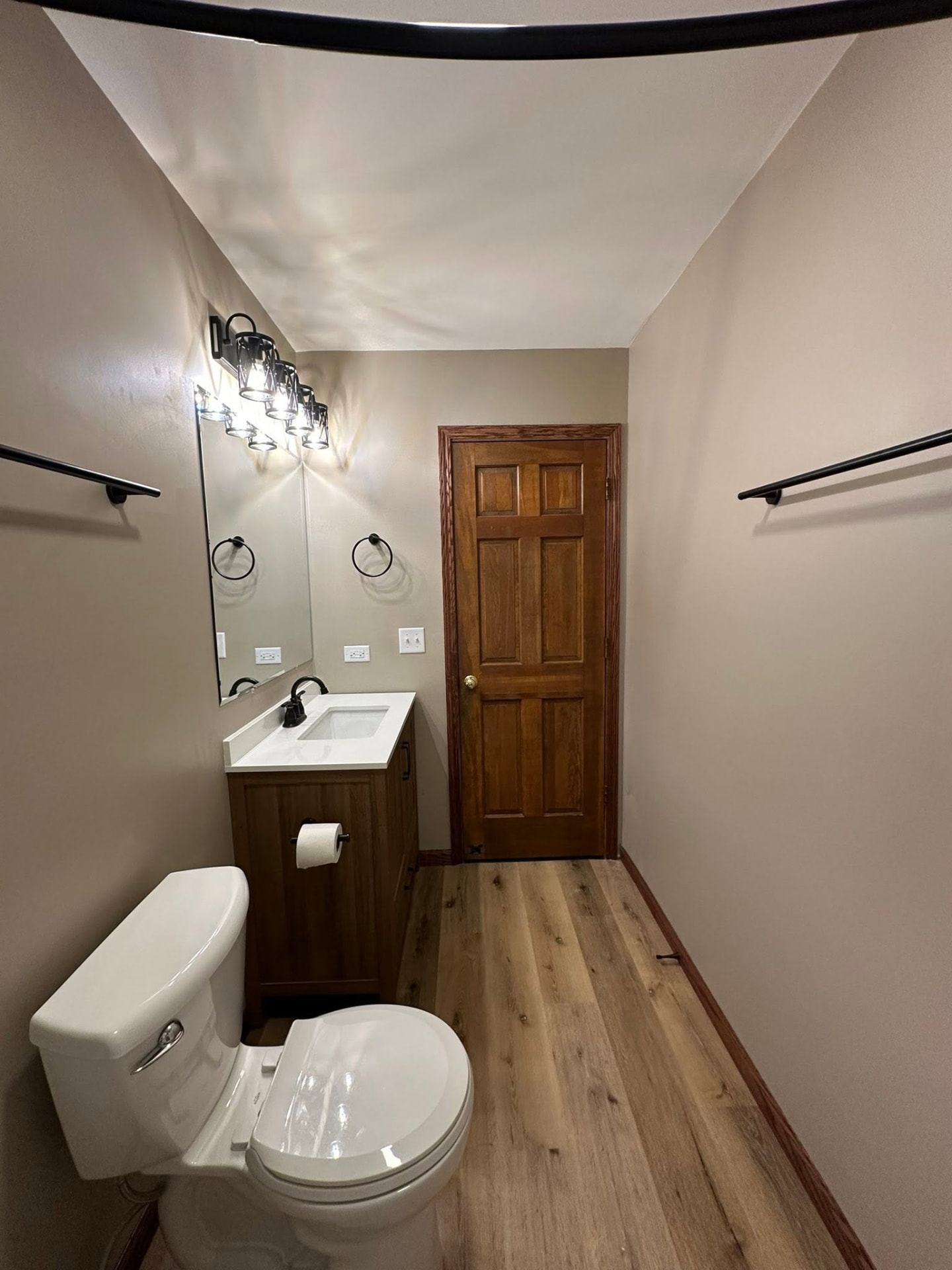 Finished bathroom with new vanity, flooring, lighting and black fixtures