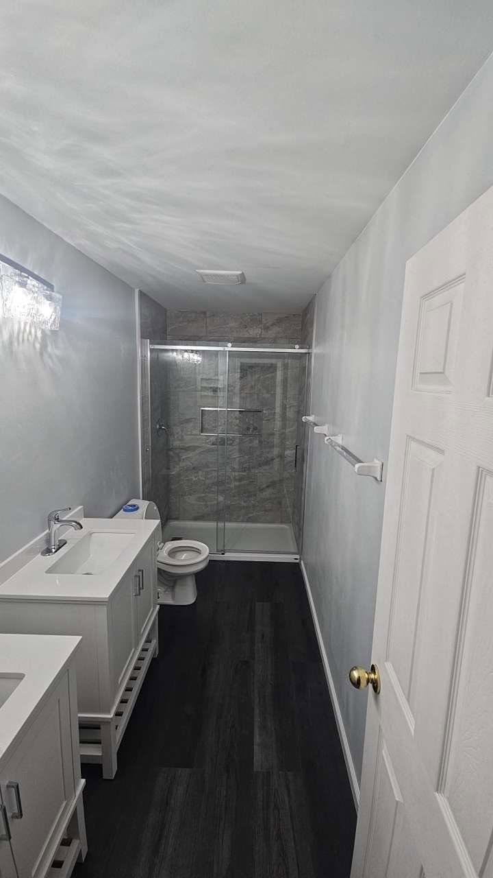Remodeled bathroom with tiled walk-in shower and new vanity