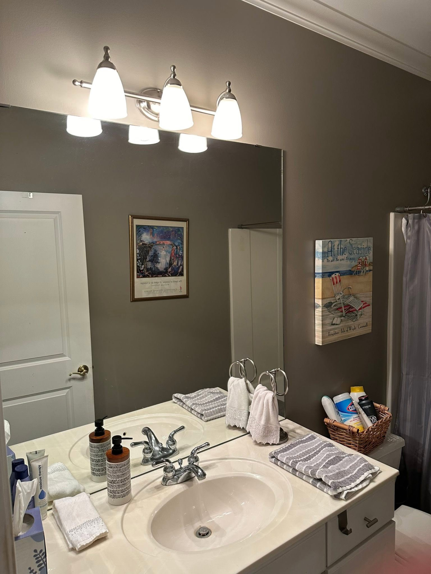 Bathroom vanity with new light fixture and large mirror