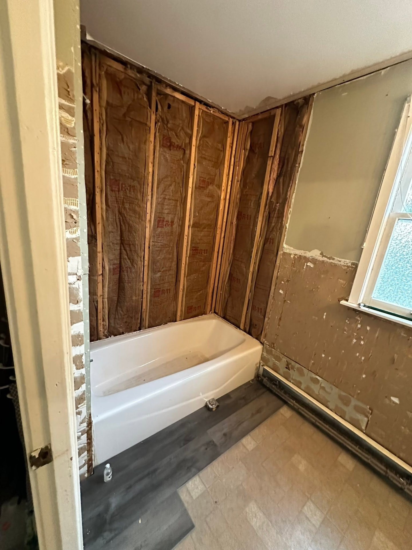 Bathroom stripped to the studs during a full tub and wall renovation