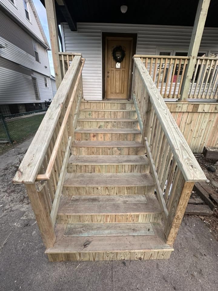 New pressure-treated porch steps with double handrails