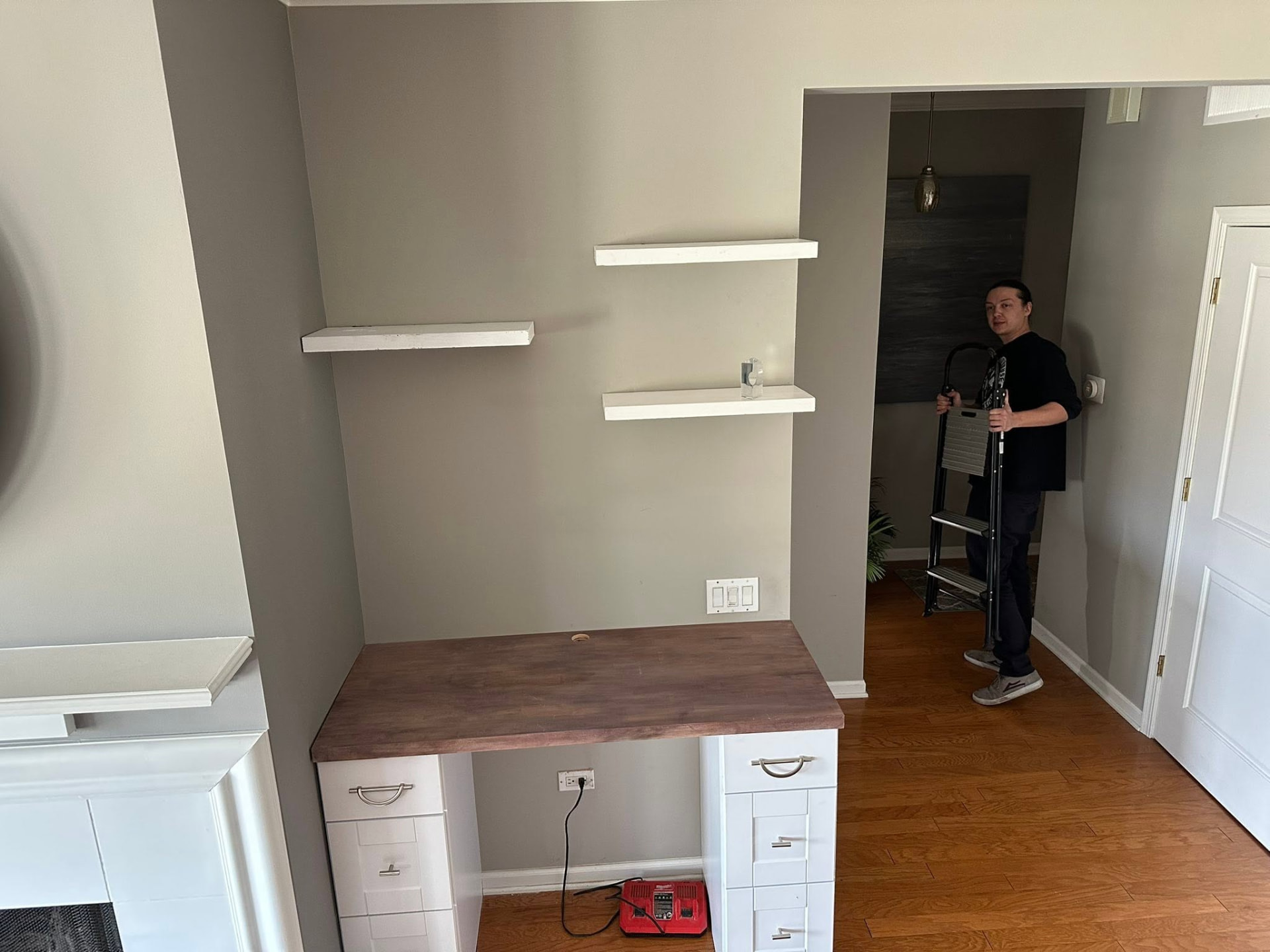 Built-in desk with butcher-block top and floating shelves