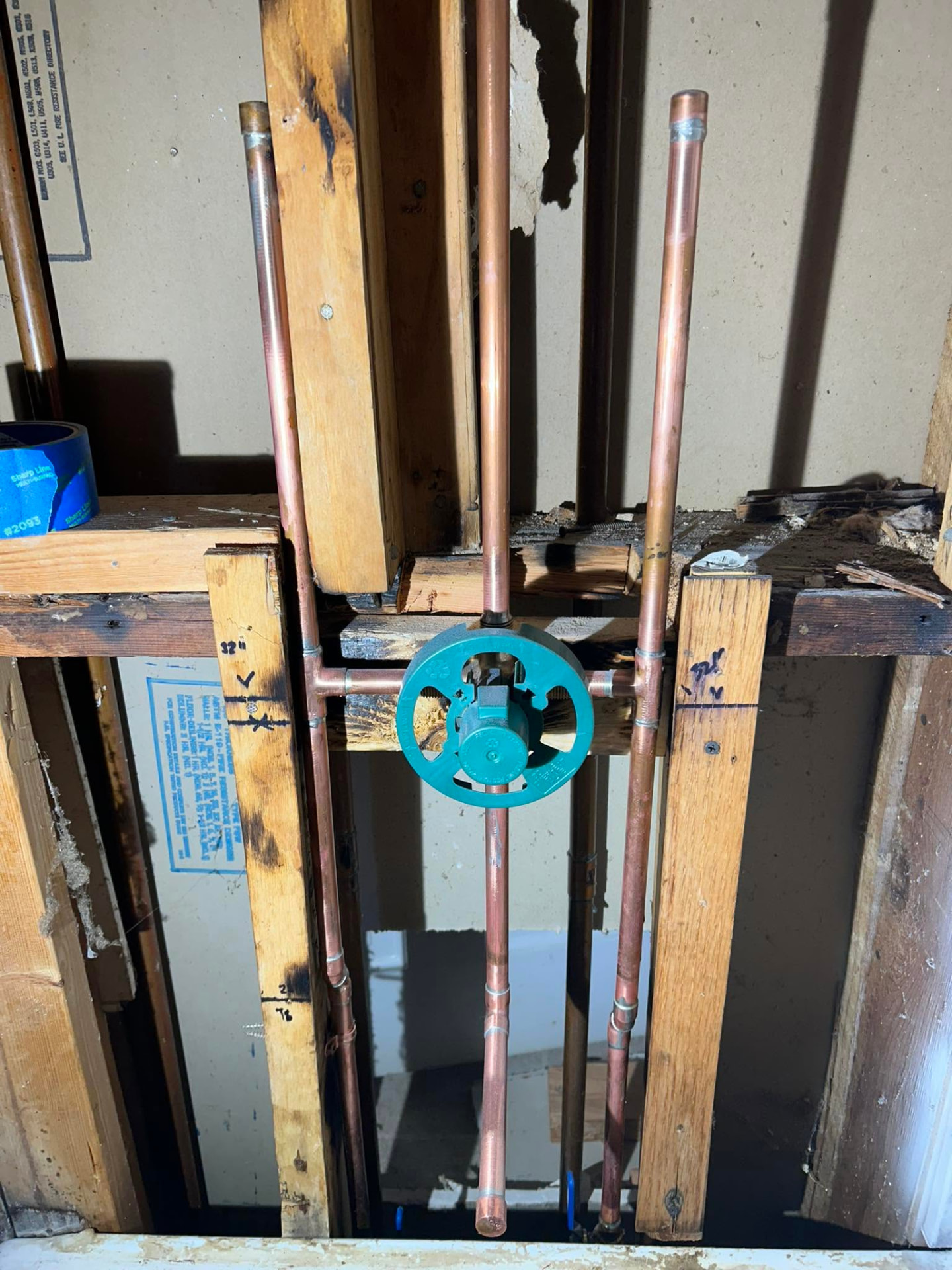 New copper shower valve rough-in installed between wall studs