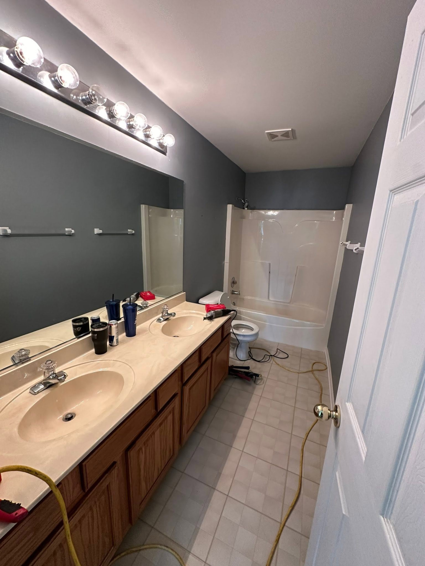 Bathroom with double vanity and tub surround before remodeling
