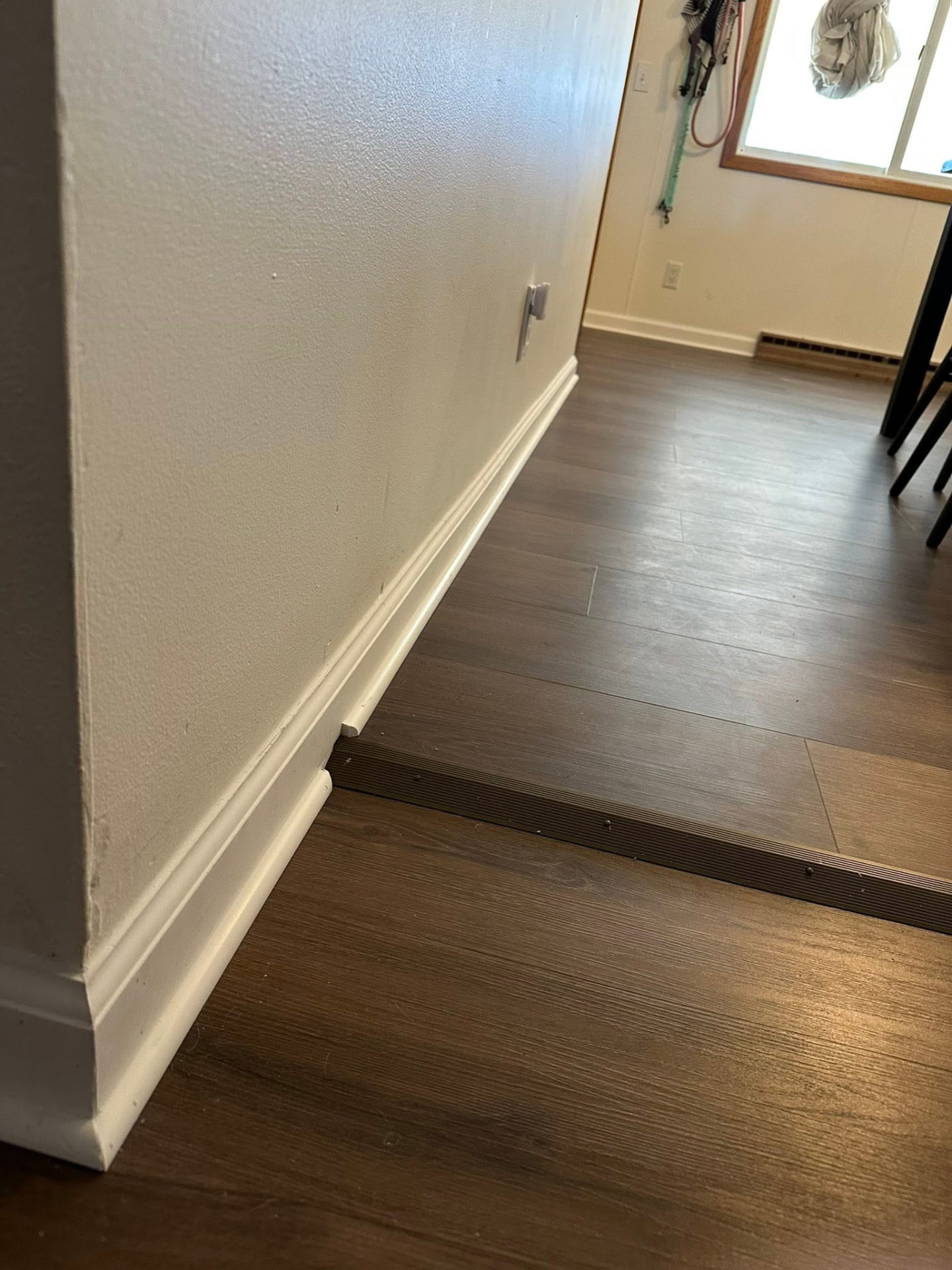 New baseboard trim and luxury vinyl plank flooring transition